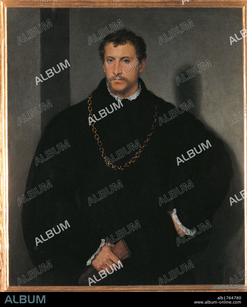 The Young Englishman, by Tiziano Vecellio known as Titian, 1525 about, 16th Century, oil on canvas, cm 112 x 95. Italy, Tuscany, Florence, Palazzo Pitti, Palatine Gallery. All. Male portrait man bearded beard mustache bust black coat white shirt chain gold glove pale complexion skin light colored eyes pearl gray background shade shadow. Authorization required for non editorial use.