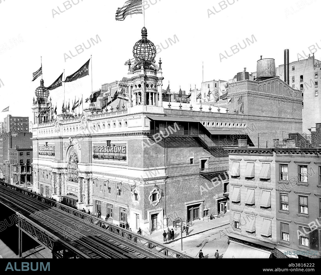 The Hippodrome Theatre was a theater in NYC from 1905-39, located on Sixth Avenue between West 43rd and West 44th Streets in the Theater District of Midtown Manhattan. It was called the world's largest theatre by its builders and had a seating capacity of 5,300, with a 100x200 foot stage. The theatre had state-of-the-art theatrical technology, including a rising glass water tank. The Hippodrome was built by Frederick Thompson and Elmer Dundy, creators of the Luna Park amusement park at Coney Island, with the backing of Harry S. Black's U.S. Realty, a dominant real estate and construction company of the time. The exterior of the red-brick and terra-cotta building was Moorish in style, with two corner towers, each of which was topped by a globe covered in electric lights. The Hippodrome's huge running costs made it a perennial financial failure, and a series of producers tried and failed to make money from the theatre. It was demolished in 1939. Photographed by the Detroit Publishing Company, 1905.