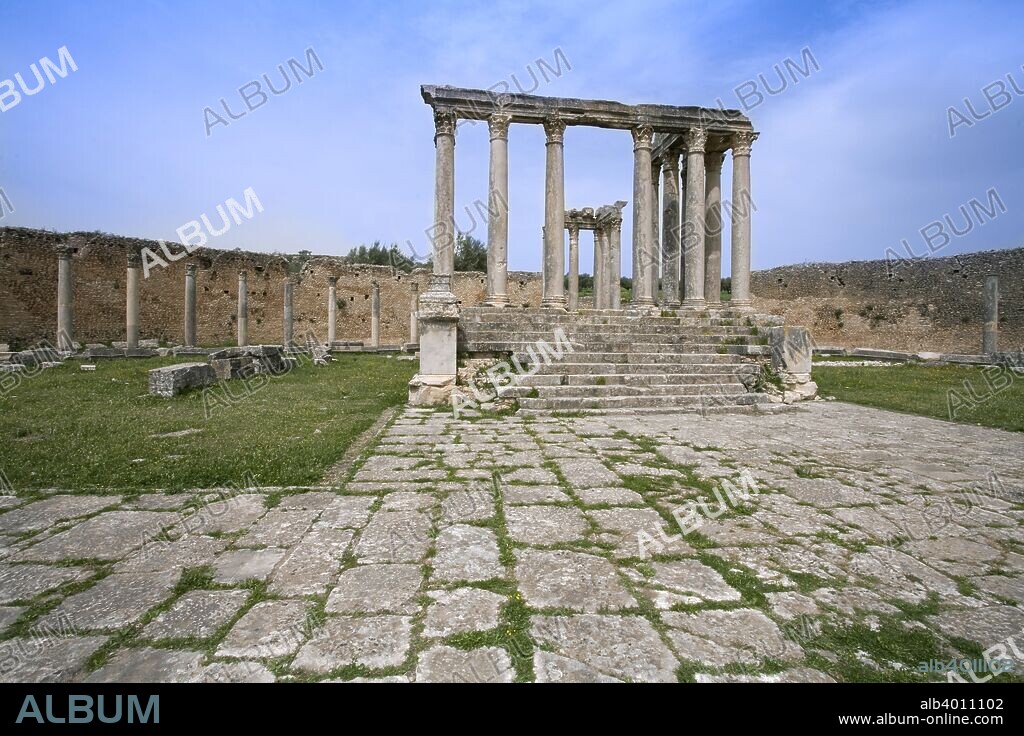 The Temple of Juno Caelestis, Dougga (Thugga), Tunisia. The Temple of Juno Caelestis was built between 222 and 235 by Julius Gabinius and his wife Julia Gabinia Venusta. The peripteral temple is surrounded by a semicircular portico which itself is enclosed by a semicircular wall. The basin for ritual purification lay between the ring wall and a subsidiary building to the east of the temple precinct. On the north side of the temple is an apse, constructed when it was converted into a church. Below the temple are the Exedra of Juno Regina, a small oratory and the Columbarium of the Remii, a Roman family tomb of the A.D. second/third century. Juno Caelestis was the Roman equivalent of the Punic goddess Tanit.