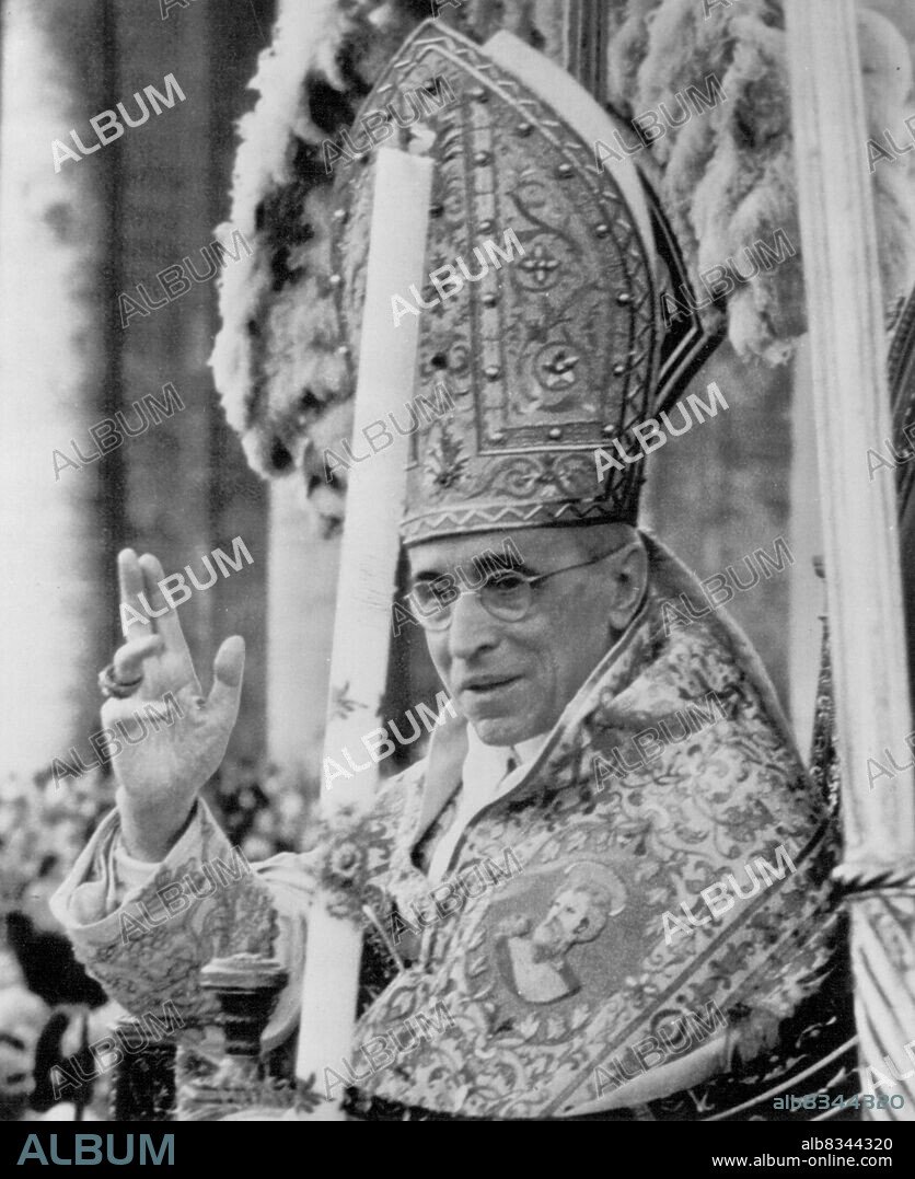 Papal Blessing--Pope Pius XII, sitting in his portable throne, is borne through crowd in St.Peter's square at the Vatican Saturday and confers his blessing on throng estimated at 500,000 during ceremony in which Giuseppe Sarto--Pope Pius X--was canonized as the newest Saint of the Roman catholic church. It was the first canonization ceremony for a Pontiff in 242 years. May 31, 1954. (Photo by AP Wirephoto).