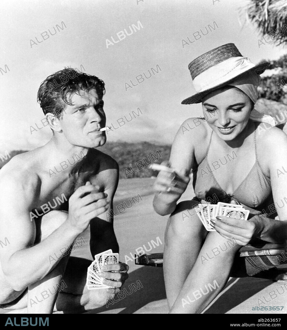 JOAN COLLINS and STEPHEN BOYD in ISLAND IN THE SUN, 1957, directed by ROBERT ROSSEN. Copyright 20TH CENTURY FOX.
