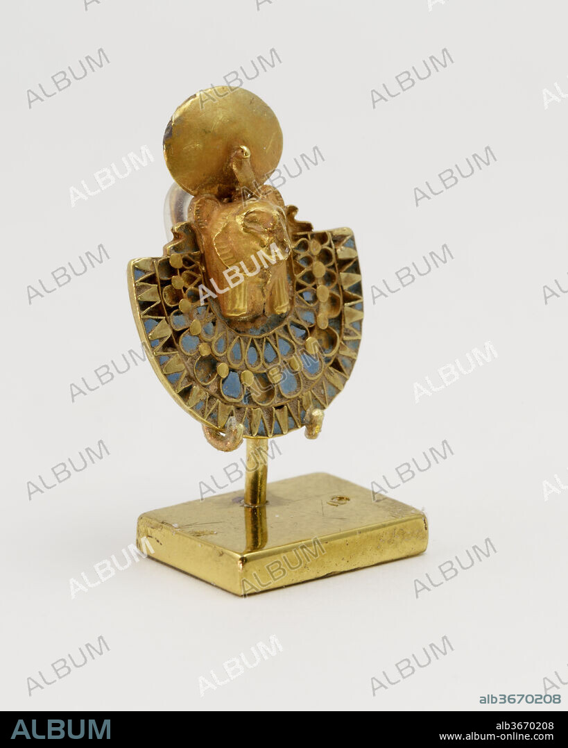 Amuletic aegis of Bastet or Sakhmet. Dimensions: H. 2.5 cm (1 in.): W. 2 cm (13/16 in.). Date: ca. 1070-664 B.C..
This small piece represents a so called aegis, which is a protective element that combines a broad collar with the head of a deity. The broad collar was a common jewellery item that consisted of several rows of beads and was worn on the chest. Here the head of a feline goddess is featured; this is possibly Sakhmet. She wears a large sun disk and a uraeus cobra on her head. Underneath her lion ruff one can see part of a human tripartite wig, a common element for animal headed deities.
