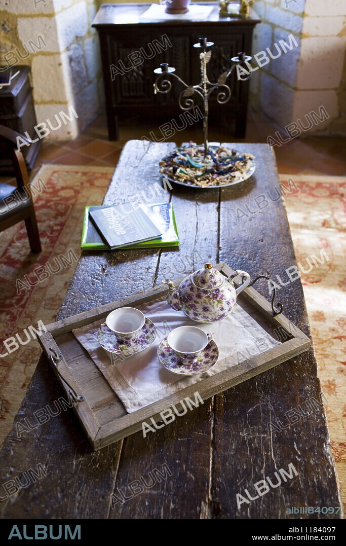 Tea tray with teapot and floral china cups in hotel, Hostellerie Les Griffons, Bourdeilles, North Dordogne, France.