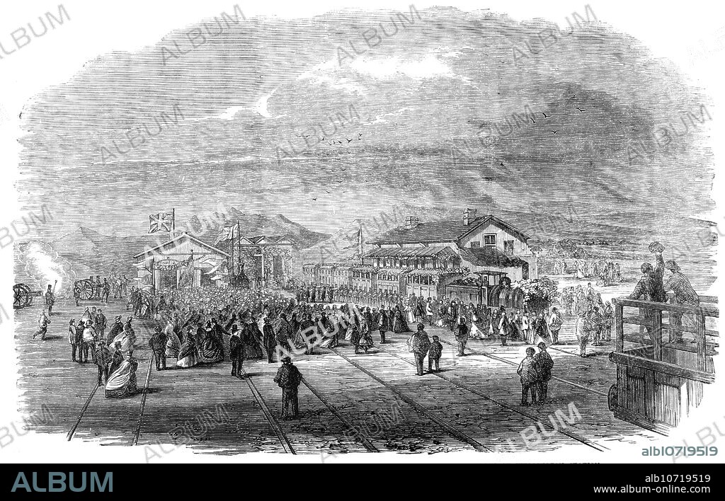 Opening of the Cape Town and Wellington Railway: arrival of the first train at Wellington Station, 1864. 'This is the only considerable railway undertaking begun in South Africa, and the first that has been finished in Cape Colony. The line, which is single, and about fifty-eight miles in length, including the extension into the city at Cape Town, crosses the Cape Flats, and ascends the Eerste River valley, passing through Stellenbosch and the Paarl, and terminates at the town of Wellington, situated at the foot of Bain's Kloof Pass...The railway was opened on the 4th of November last by Sir Philip Wodehouse, Governor of Cape Colony...On the arrival of the train the volunteers, under the command of Colonel Hill, presented arms, the band played "God Save the Queen," the cannon of the artillery thundered a Royal salute, and the immense crowd...cheered until they were hoarse. Amid the clamour his Excellency the Governor descended from his carriage and formally declared the line to be open. The numerous guests found ample accommodation in the goods' shed, tastefully decorated, where an elegant repast was prepared...During the day twelve hundred persons travelled over the line without the slightest accident'. From "Illustrated London News", 1864.