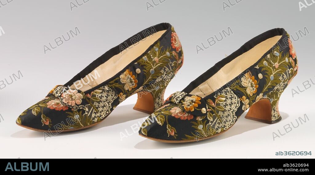 Evening slippers. Culture: French. Designer: J. Ferry. Date: 1880.
By the last quarter of the 19th century, shoes specifically matched to a particular evening dress became an increasingly common phenomenon.  While white shoes could be economically dyed to coordinate with a special dress, the wealthiest clients would have shoes specifically made to match.  This pair of top quality evening slippers features an eye catching fabric which has been carefully cut to make the most of the pattern.  The shoes were made to match a Parisian couture evening dress.