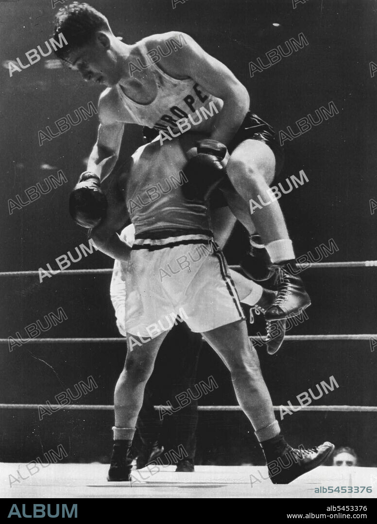 High Spot In International Bouts -- Stig Sjolin of Varanamo, Sweden. is hoisted to the shoulder of Richard Guerrero of Chicago, as the action became fast and furious tonight in l60»pound International Golden Gloves bout at Stadium tonight, Guerrero was awarded a decision. March 30, 1951. (Photo by AP Wirephoto).