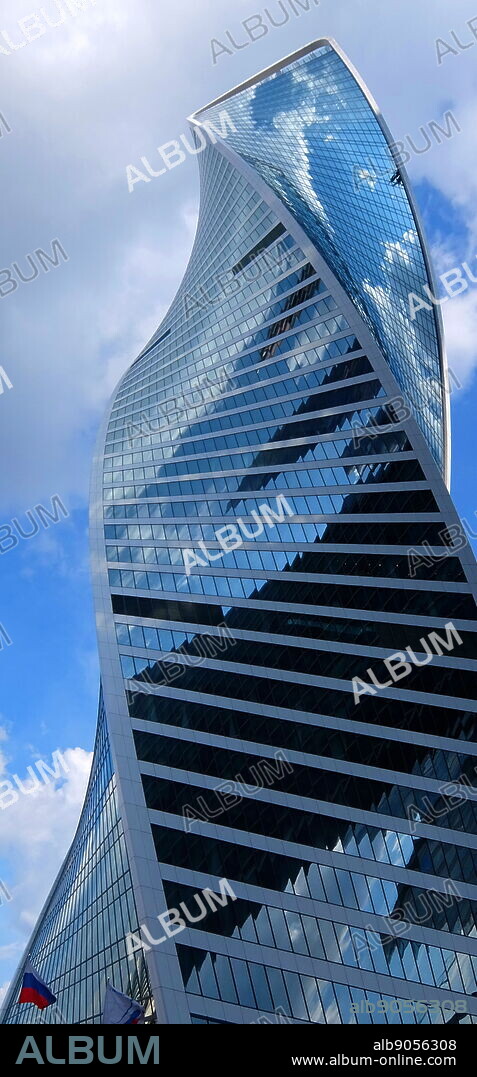 The Evolution Tower skyscraper, located in the Moscow International Business Center in Moscow, Russia. The 55-story office building has a height of 246 metres (807 ft) and a total area of 169,000 square metres (1,820,000 sq ft). Noted in Moscow for its futuristic DNA-like shape, the building was designed by British architect Tony Kettle in collaboration with University of Edinburgh's Professor of Art Karen Forbes. Construction of the tower began in 2011 and completed in late 2014.
