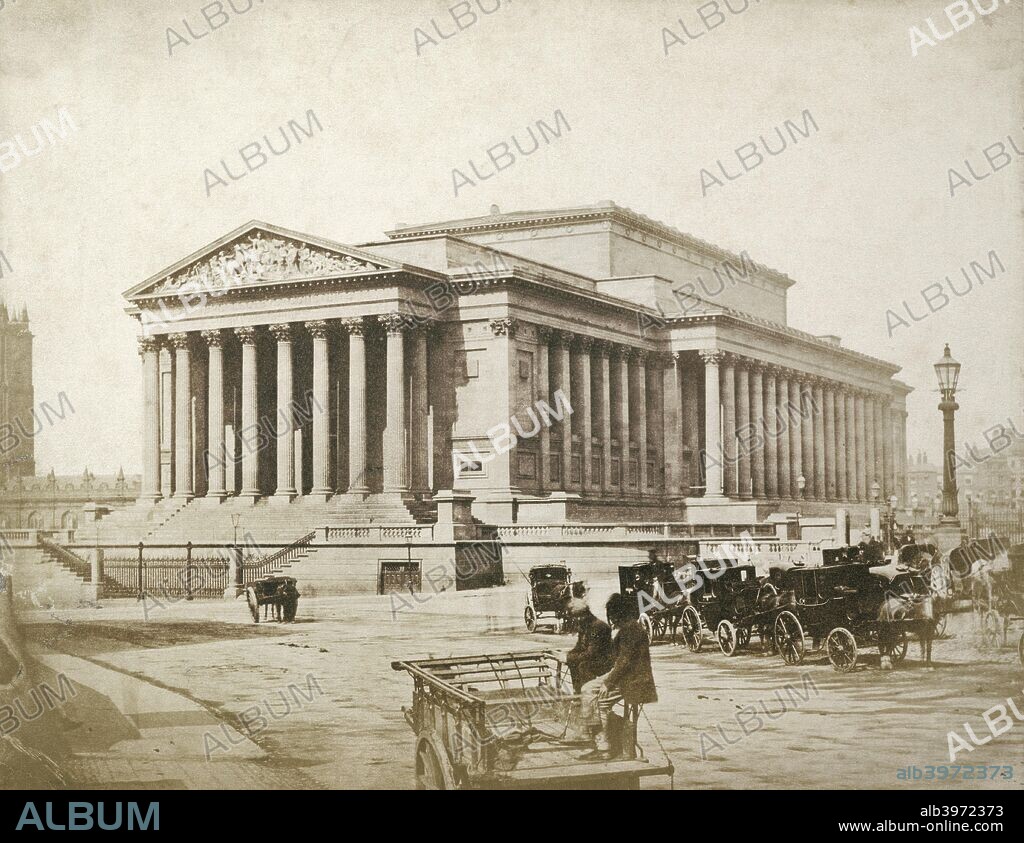 St George's Hall, St George's Plateau, Liverpool, 1854-1855. Salted paper print. Cabs stand outside the newly built neoclassical St George's Hall, designed by Harvey Lonsdale Elmes and completed by Charles Robert Cockerell. The building, combining a public hall and law courts, was erected between 1841 and 1856. The photograph is attributed to Thomas Sutton because the original mount bears the name of the Frenchman Louis-Désiré Blanquart-Evrard, who published some of Sutton's negatives in 1854. Sutton and Blanquart-Evrard opened a printing establishment on Jersey in 1855, and launched the journal Photographic Notes the following year. Sutton was a prolific writer on photography, and published A Dictionary of Photography in 1858.