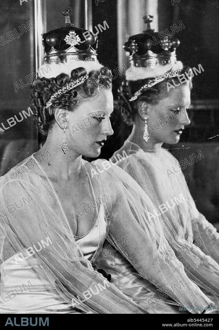 The Official Coronation Hair styles -- These styles have been designed by expert hairdressers under the direction of the incorporated guild of hair dressers, wig makers and perfumers, and are shown in London. Called the curl crown Halo. This style can be worn with Tiara, Coronet, or purely as an evening style. It is seen here worn with a Duchess's Coronet. March 23, 1937. (Photo by Sport & General Press Agency, Limited).