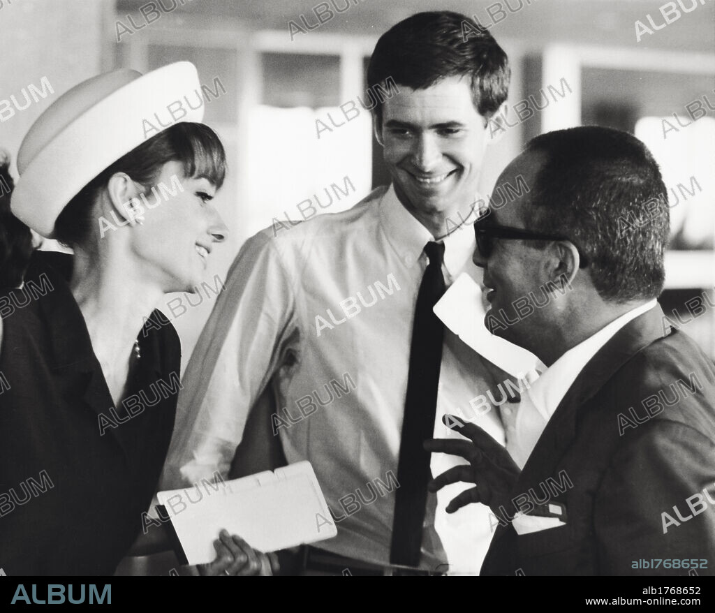 Anthony Perkins with Audrey Hepburn. The American actor Anthony Perkins smiling in the company of British actress Audrey Hepburn. Paris, July 1962.