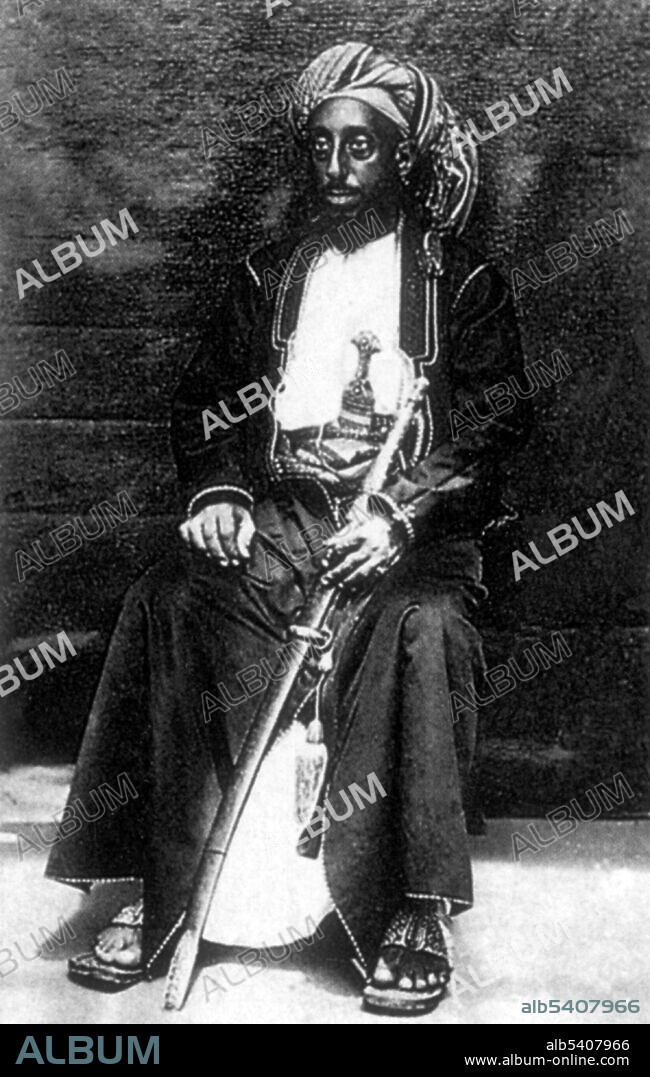 Tippu Tip (1832 - June 14, 1905), real name Hamad bin Muhammad bin Juma bin Rajab el Murjebi, was a Swahili-Zanzibari slave trader, ivory trader, explorer, plantation owner and governor of Stanley Falls. He worked for a succession of the sultans of Zanzibar. Tippu Tip traded in slaves for Zanzibar's clove plantations. As part of the large and lucrative ivory trade, he led many trading expeditions into Central Africa by constructing profitable trading posts that reached deep into the region. He bought the ivory from local suppliers and resold it for a profit at coastal ports. No photographer credited, undated.