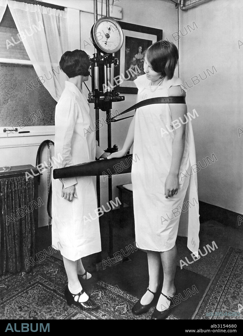 Battle Creek, Michigan:  c. 1930. Testing the strength of a patient's muscles of the trunk at the Kellogg's Battle Creek Sanitarium.