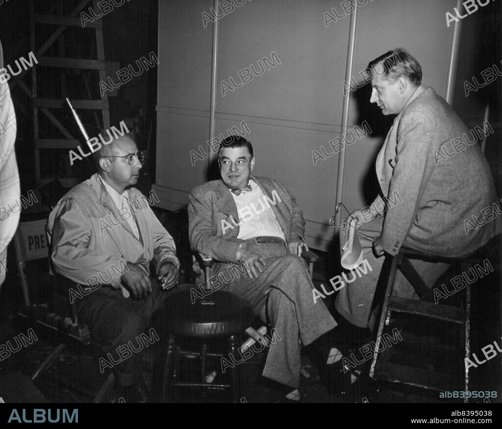 Huddle Of "The Brains"... On the set of Metro-Goldwyn-Mayer's "The Beginning or the End", gripping story of the atom bomb, a discussion of complex phases of the picture takes place between Director Norman Taurog, Studio Executive James K. McGuinness and Dr. Henry T. Wensel, one of the film's eight technical advisors. Robert Walker and Brian Donlevy head the picture 'W Wtellar cast, which includes Tom Deake, Beverly Tyler, Audrey Totter, Home Cronyn, Hurd Hatfield and Joseph Calleia. Samuel Marx produced. June 4, 1953.