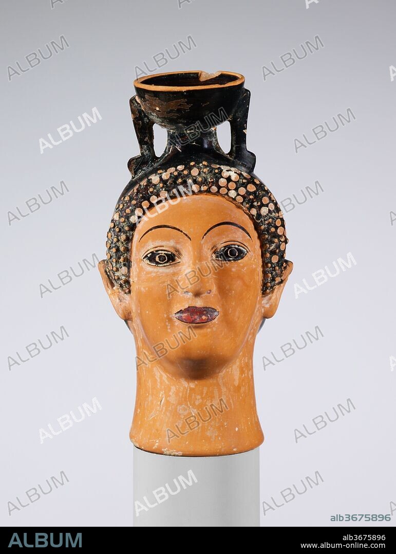 Terracotta aryballos (perfume bottle) in the shape of a woman's head. Culture: Greek, Attic. Dimensions: H. 4 7/16 in. (11.3 cm). Date: ca. 500 B.C..
In an object such as this one, the appurtenances related to its function are limited to the spout and small handles at the top. Thus, the demarcation between a vase, a terracotta, and a sculpture is narrow indeed.