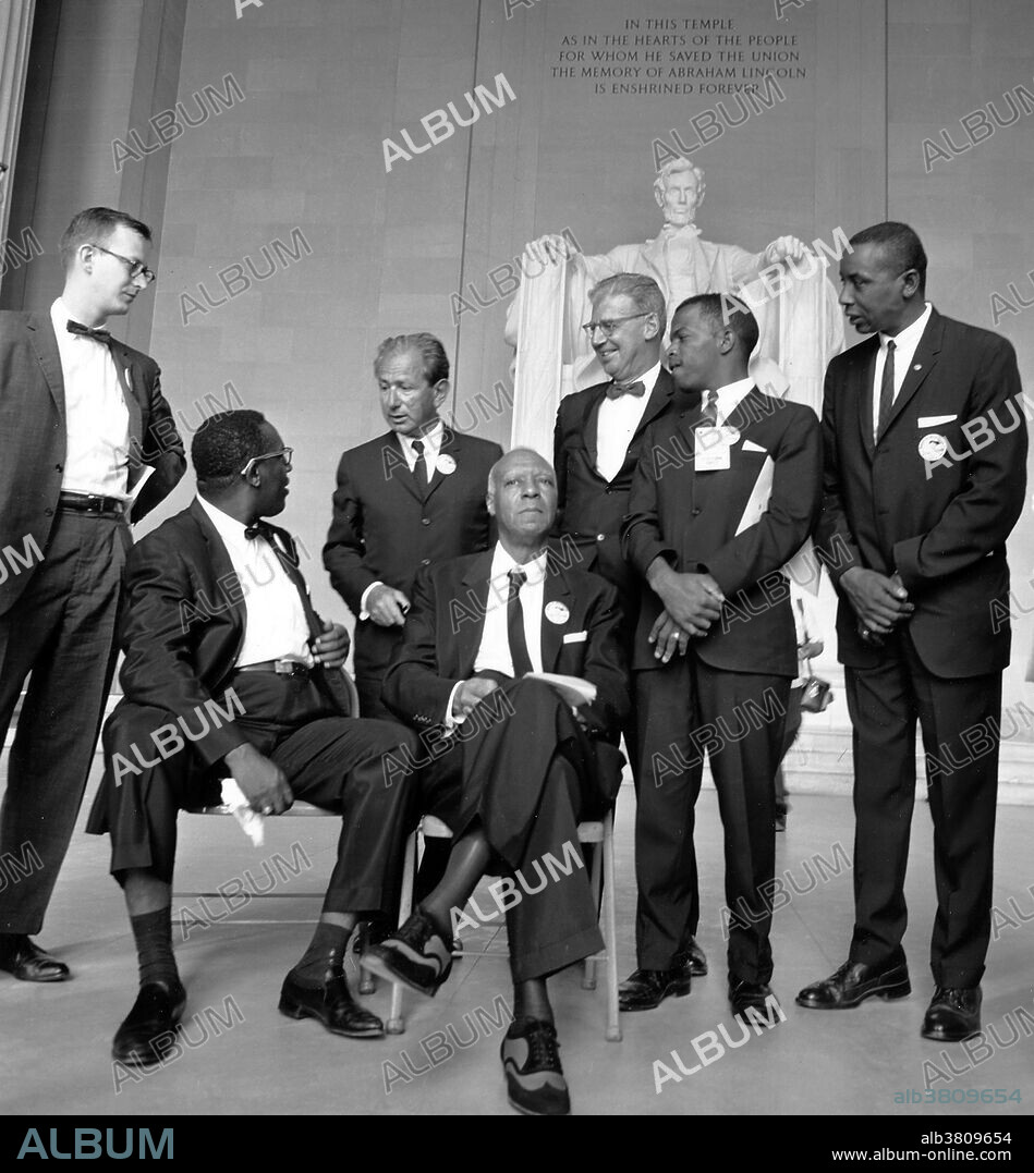 Entitled: "Leaders of the march (from left to right) Mathew Ahmann, Executive Director of the National Catholic Conference for Interracial Justice; (seated with glasses) Cleveland Robinson, Chairman of the Demonstration Committee; (standing behind the two chairs) Rabbi Joachim Prinz, President of the American Jewish Congress; (beside Robinson is) A. Philip Randolph, organizer of the demonstration, veteran labor leader who helped to found the Brotherhood of Sleeping Car Porters, American Federation of Labor, and a former vice president of the American Federation of Labor and Congress of Industrial Organizations; (wearing a bow tie and standing beside Prinz is) Joseph Rauh, Jr, a Washington, DC attorney and civil rights, peace, and union activist; John Lewis, Chairman, Student Nonviolent Coordinating Committee; and Floyd McKissick, National Chairman of the Congress of Racial Equality." The March on Washington for Jobs and Freedom, August 28, 1963, was one of the largest political rallies for human rights in US history and called for civil and economic rights for African-Americans.