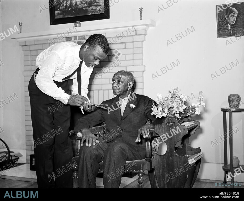Dr. George Washington Carver talking to member of Reserve Officers Training Corps, Tuskegee Institute, Tuskegee, Alabama, USA, Arthur Rothstein, U.S. Office of War Information, March 1942.