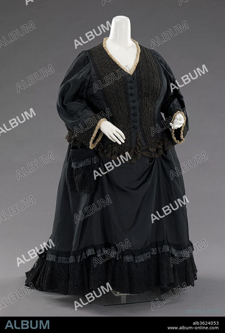 Mourning dress. Culture: British. Date: 1894.
This dress was once worn by Queen Victoria (1819-1901) of the United Kingdom, as documented in an 1894 photograph of the Queen holding her great-grandson, Edward VIII (1894-1972).  Purchased from an annual sale of the Queen's garments, it shows the traditional touches of mourning attire, which she wore from the death of her husband, Prince Albert (1819-1861), until her own death.  The simple white trim and minimal use of crinkled crepe on the dress indicate a state of half mourning, although it is 33 years after her husband's death.  The bodice is of a lighter material to allow for comfort during summer months and the entire garment is finely detailed inside and out. 
Black mourning dress reached its peak during Queen Victoria's reign.  She set the standard by wearing mourning for half of her life.  With these standards in place, it was considered a social requisite to don black from anywhere between three months to two and a half years while grieving for a loved one or monarch.  The stringent social custom existed for all classes and was available at all price points.  Those who could not afford the change of dress often altered and dyed their regular garments black.  The amount of black to be worn was dictated by several different phases of mourning; full mourning ensembles were solid black while half mourning allowed the wearer to add a small amount of white or purple.