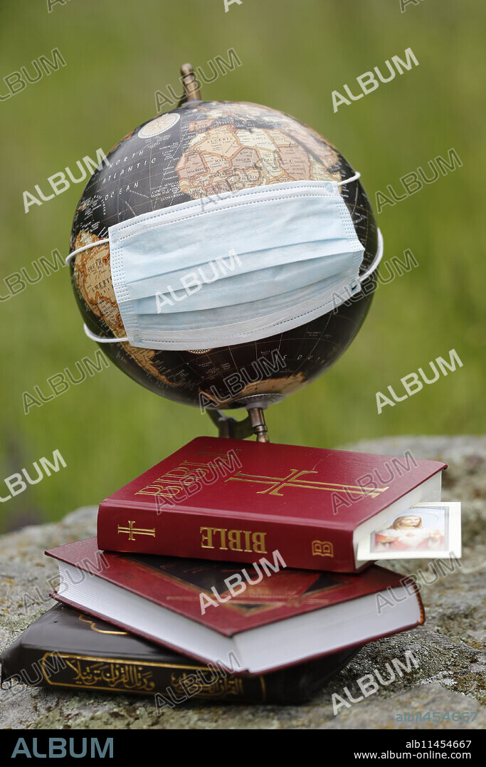 Coronavirus (Covid-19), global pandemic, World map with surgical mask and Bible, Koran and Torah, Interreligious dialogue, France, Europe.