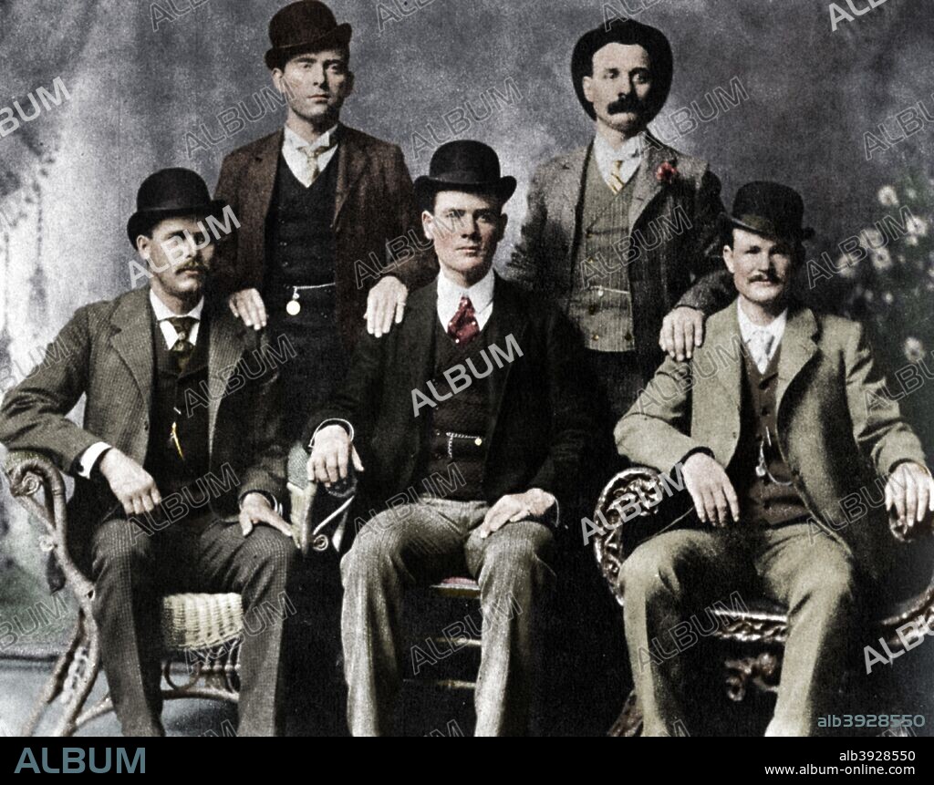 The Wild Bunch, American outlaw gang, 1901 (1954). Left to right, standing, William Carver (News Carver), Harvey Logan (Kid Curry); sitting, Harry Longabaugh (Sundance Kid), Ben Kilpatrick (The Tall Texan), Robert LeRoy Parker (Butch Cassidy). The gang operated out of the Hole-in-the-Wall Pass in Wyoming, a notorious haunt of outlaw groups, between 1889 and 1901 robbing trains and banks across the West. Their activities came to an end in 1901. Butch Cassidy and the Sundance Kid emigrated to South America (they are said to have been killed by Bolivian police after a robbery in 1908), Carver was killed in a shootout with lawmen, and Kilpatrick was captured in Tennessee and sentenced to 20 years in jail. Kid Curry, the most notorious member of the gang in terms of the number of people he killed, was shot and killed in a gunfight with lawmen in Colorado in 1904. Kilpatrick was released from prison in 1911 but was shot and killed the following year while robbing a train near Sanderson, Texas. (Colorised black and white print).