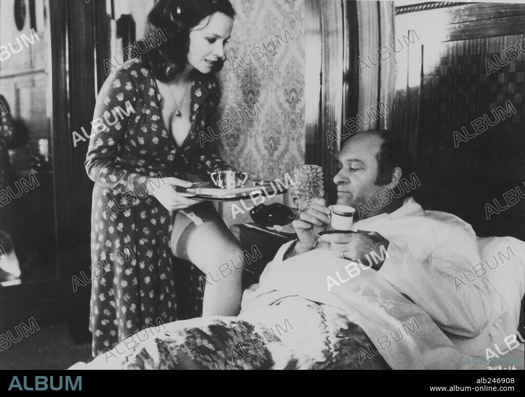 LAURA ANTONELLI and TURI FERRO in MALICIOUS, 1973 (MALIZIA), directed by SALVATORE SAMPERI. Copyright PARAMOUNT PICTURES.