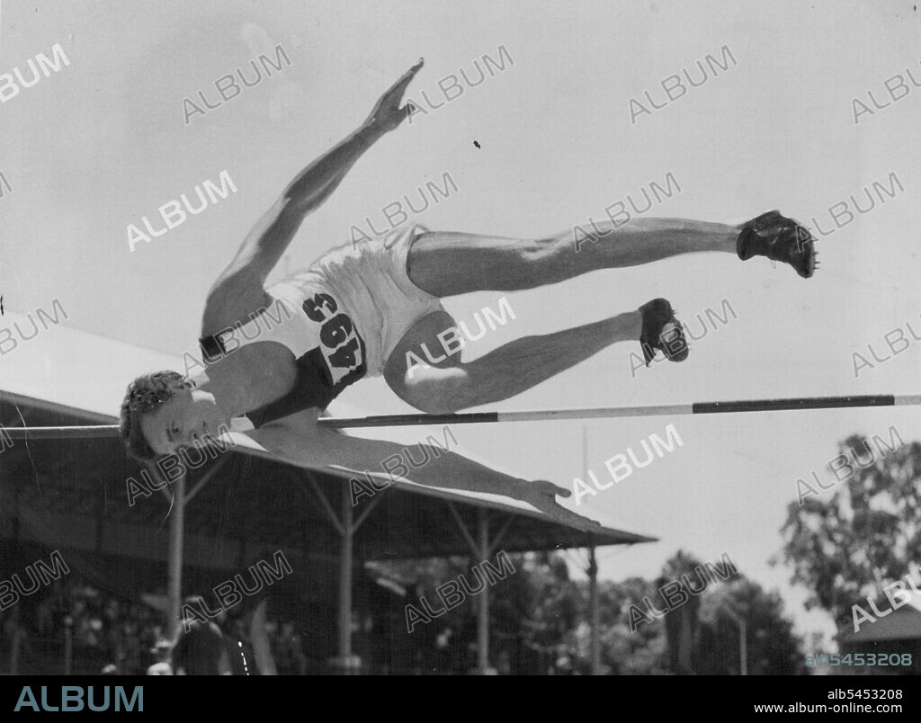 Doug Stuart, the athlete, coming out of his Western roll after clearing the bar at 6ft 6¼in at Leaderville (WA), prior to this year's National titles. January 19, 1953.