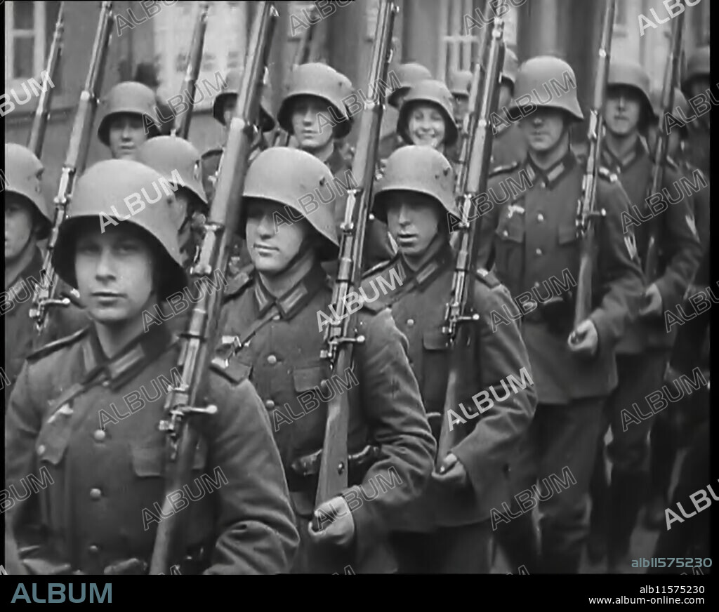 German Troops Moving Through the Rhineland, 1936. '...in the...demilitarised Rhineland, the tramp of soldiers' boots across the bridges had demonstrated to the World that Germany's VIP [ie Hitler] had an unusually vigorous mind. Afterwards, they found out that Hitler's troops had orders to withdraw at the first sign of opposition. "So what", some said, "after all the Rhineland is Germany", but it wasn't exactly something to cheer about'. On 7 March 1936, in violation of the Treaty of Versailles, German troops marched into the Rhineland and other regions along the Rhine. German territory west of the Rhine had been off-limits to the German military. (The Hugo Boss clothing company used forced labour drawn from German-occupied territories and POW camps, to manufacture uniforms for the SS and later the Wehrmacht). From "Time To Remember -  The Time Of The Three Kings", 1936 ( Reel 1); documentary about events of the year of the abdication crisis.