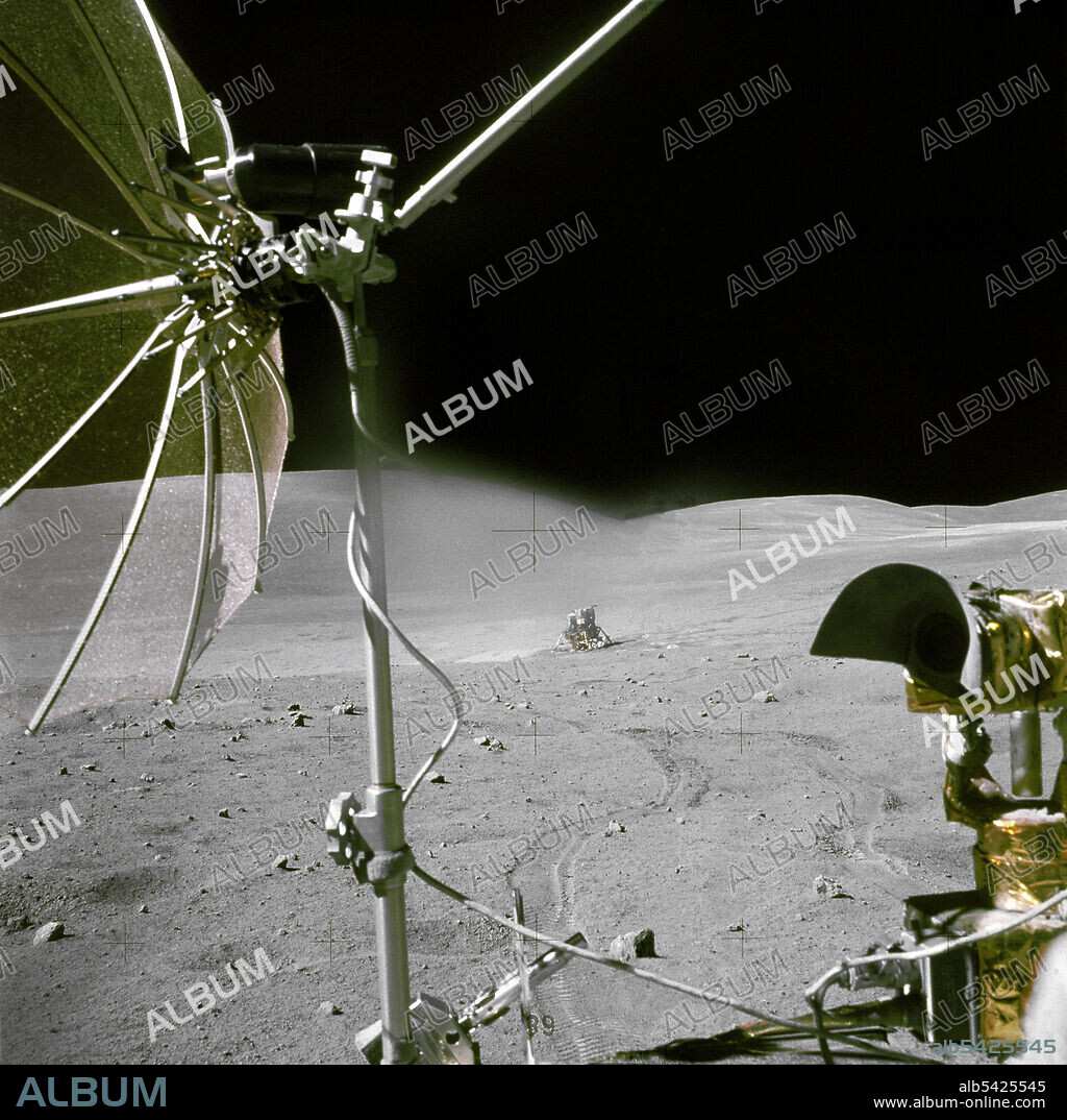 CHARLES DUKE. Orion seen from the Rover, lunar surface, 1972. The Apollo 16 Lunar Module "Orion" is photographed from a distance by astronaut Charles M. Duke Jr., Lunar Module pilot, aboard the moving Lunar Roving Vehicle. Astronauts Duke and Commander John W. Young, were returing from the third Apollo 16 extravehicular activity (EVA-2). The RCA color television camera mounted on the LRV is in the foreground. A portion of the LRV's high-gain antenna is at top left.