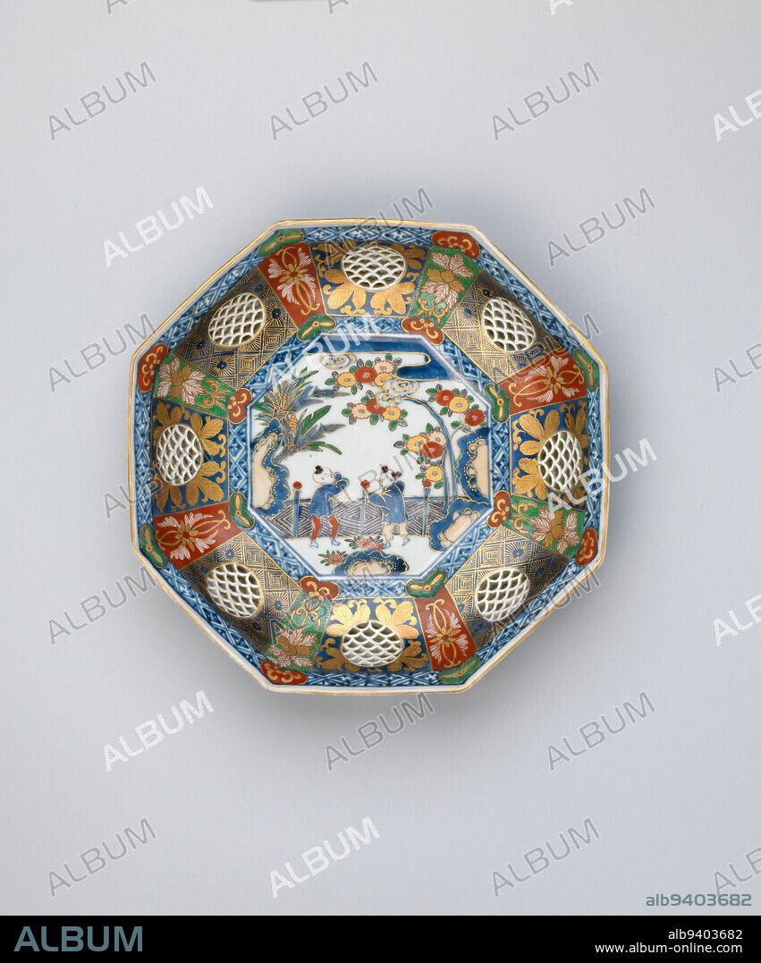 Dish with Chinese boys in a garden, 19th century, Unknown Japanese, 2 1/16 × 9 1/2 × 9 3/8 in. (5.24 × 24.13 × 23.81 cm), Imari ware; porcelain with underglaze cobalt blue, overglaze enamels, and gold, Japan, 19th century, In the center of this dish, two Chinese boys wearing ancient Chinese garb are surrounded by garden rocks, tropical plants, and flowering trees, all depicted in the standard iro-e colorsgreen, red, yellow, and gold over underglaze blue. The fence behind the boys helps identify their location as a palace garden. Pictures of aristocratic ancient Chinese boys in gardens had been introduced by the 1300s from China, where they appeared as good luck motifs on paintings, ceramics, and lacquerware. They remained a popular pictorial motif on Japanese decorative objects through the 1800s.