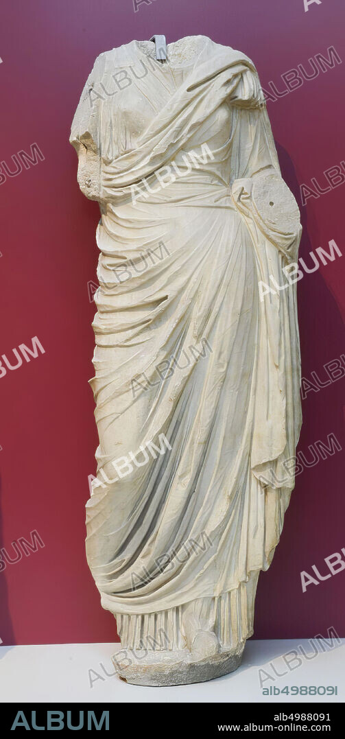 Statue of a draped woman. Lower arms, neck and head are missing. Beautifully pleated chiton with himation. Member imperial family ?, sculpture, marble, 180 x 65 x 40 cm, 875 kg, imperial age 50.