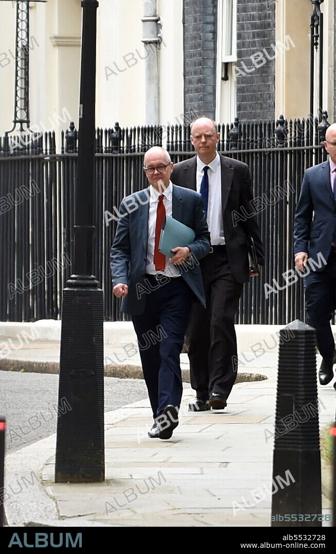 Prof Chris Whitty, the UK government's Chief Medical Officer, and Sir Patrick Vallance, British Government Chief Scientific Adviser and Head of the Government Science and Engineering, leave No.10 Downing Street to attend a press briefing headed by the UK PM Boris Johnson which outlined a relaxation of lockdown rules amid the COVID-19 Coronavirus pandemic. July 2021.