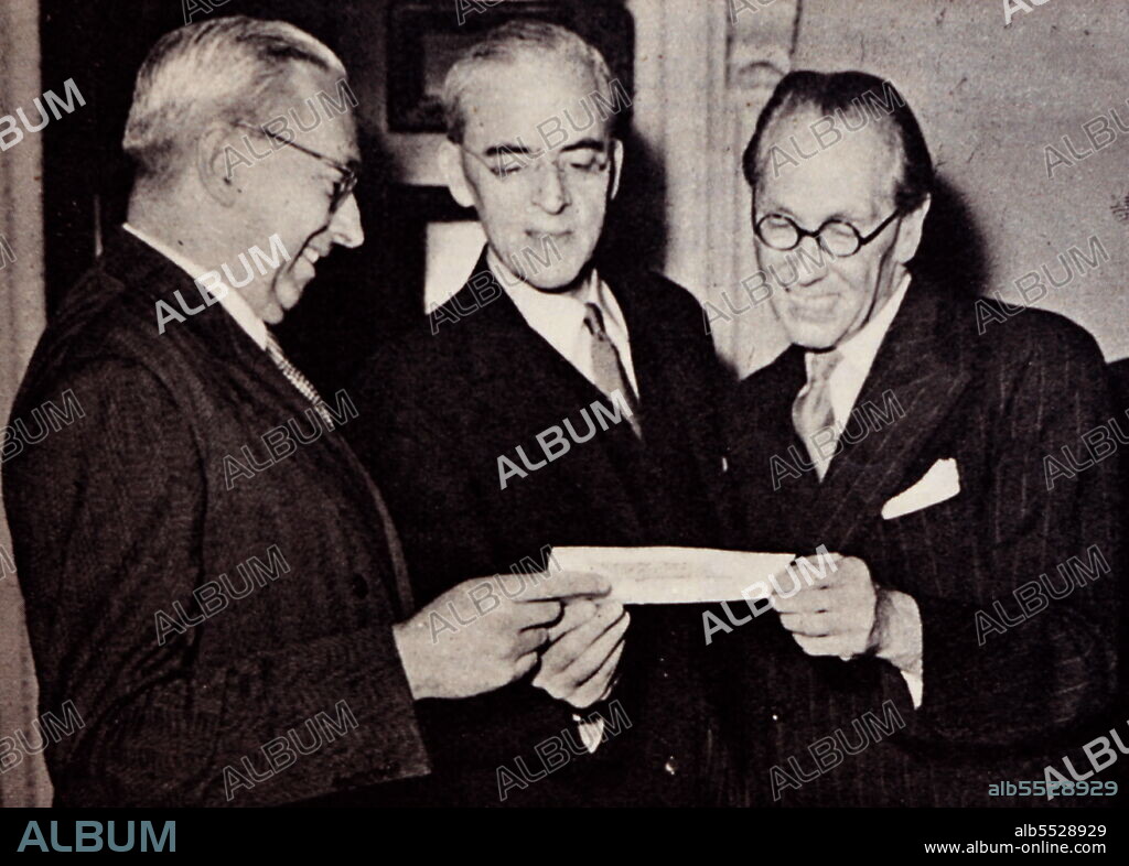 The third gift from Australia in three years. Sir Stafford Cripps receiving a cheque from Mr Mighell. Sir Richard Stafford Cripps CH QC FRS (24 April 1889 - 21 April 1952) was a British Labour Party politician, barrister, and diplomat. Sir Norman Rupert Mighell CMG (12 June 1894 - 13 April 1955) was an Australian ANZAC Officer, Gallipoli survivor, company director, public servant, and diplomat. After his military service, Mighell directed many companies and later served Australia as the Deputy High Commissioner for Australia in London.