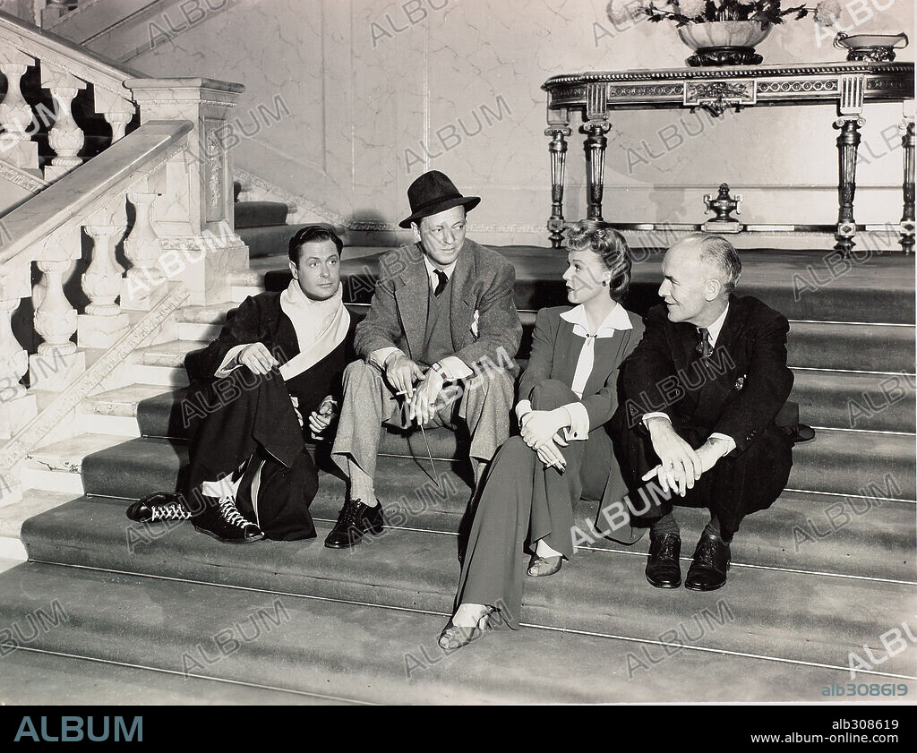 ALEXANDER HALL, JAMES GLEASON, RITA JOHNSON and ROBERT MONTGOMERY in HERE COMES MR. JORDAN, 1941, directed by ALEXANDER HALL. Copyright COLUMBIA PICTURES.
