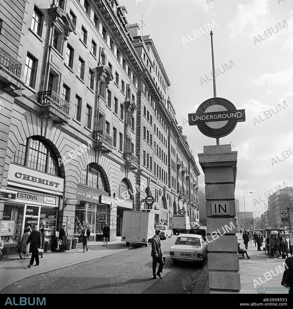 Baker Street underground station, London, 1960-1972. The Underground sign in front of the shops and station entrance on the Marylebone Road elevation of Chiltern Court flats.