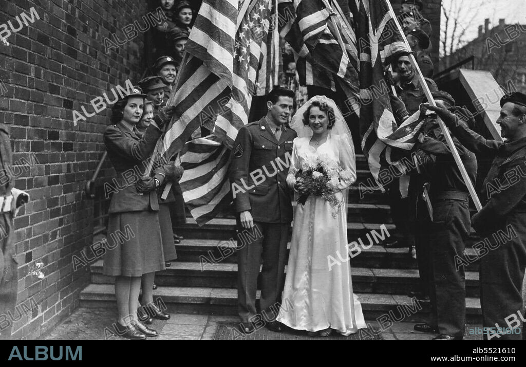 Anglo American Wedding In Berlin -- This pretty bride is ATS Private Joyce Wiltshire of Grand Parade, Harringay, London, married in Berlin to James Kerrigan of New Haven Connecticut U.S.A.. The couple met 2 years ago in London whilst they were both working at Shaef, and the romance was renewed later in Berlin.The bridal pair at the R.C. Church of the Holy Spirit, Charlottenberg, Berlin. December 24, 1945. (Photo by Mirror Features).
