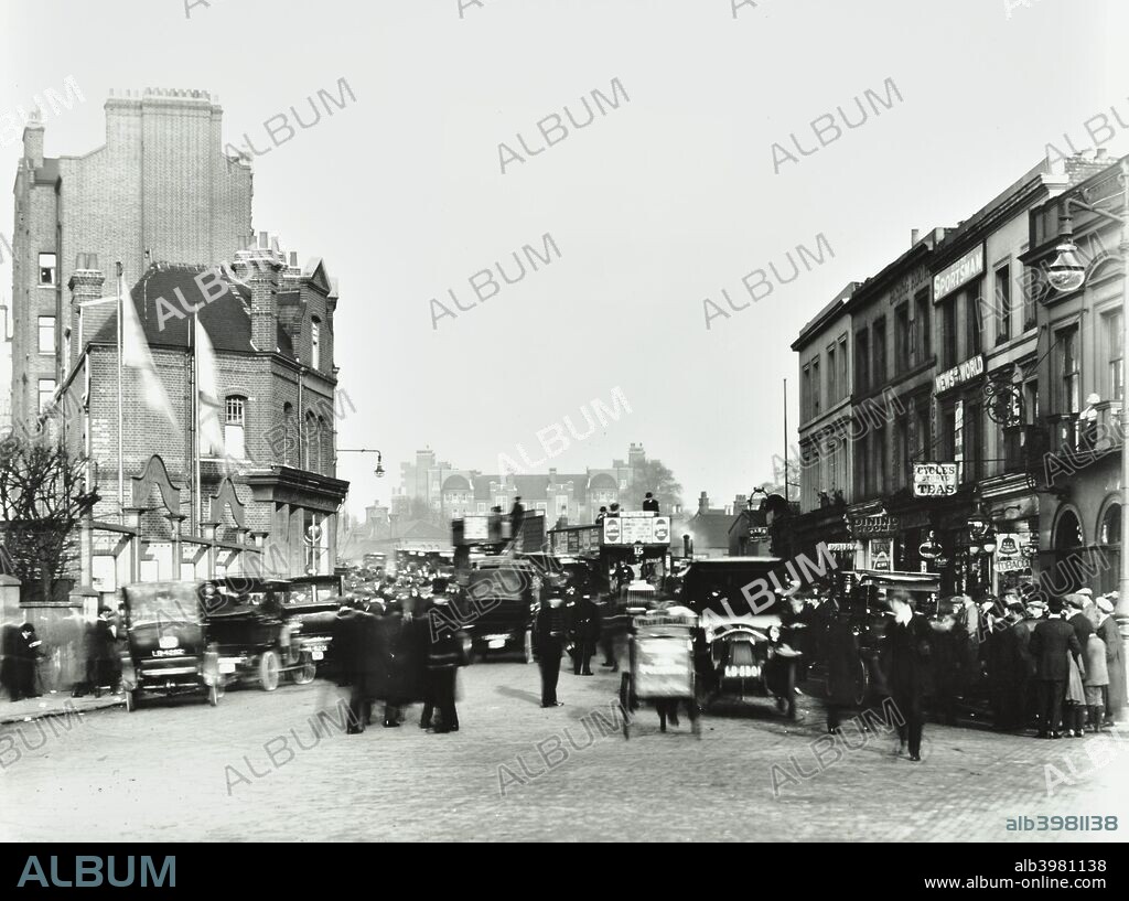Fulham Road by Stamford Bridge Stadium, (Chelsea Football Ground), Fulham, London, 1912. People, cars and buses are crowded outside the entrance to the ground.