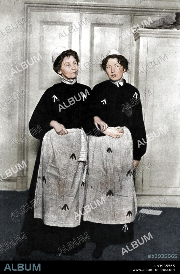 Emmeline and Christabel Pankhurst, English suffragettes, in prison dress, 1908. Emmeline Pankhurst (1857-1918) and her daughter Christabel (1880-1958), were among the leaders of the campaign to secure the vote for women. Their militant tactics resulted in their being arrested on numerous occasions (12 times in one year in Emmeline's case). In 1908, the women served 2 months apiece in Holloway Prison after leading a deputation to Parliament and inciting the crowd to 'rush' the House of Commons. (Colorised black and white print).