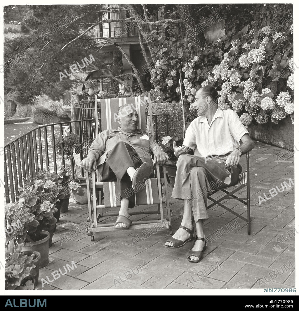 Arnoldo Mondadori with Indro Montanelli. The publisher Arnoldo Mondadori on the terrace of his villa conversing with the journalist Indro Montanelli. Portofino, 1953.