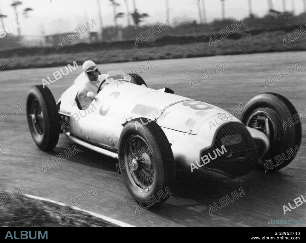 Dick Seaman's Mercedes, Donington Grand Prix, 1938. He finished third in the race. Seaman began his racing career driving a Bugatti in 1933. He won several races in the 1930s, and joined the works Mercedes team in 1937. He won the German Grand Prix in 1938, but was killed in an accident in the wet at Spa the following year.