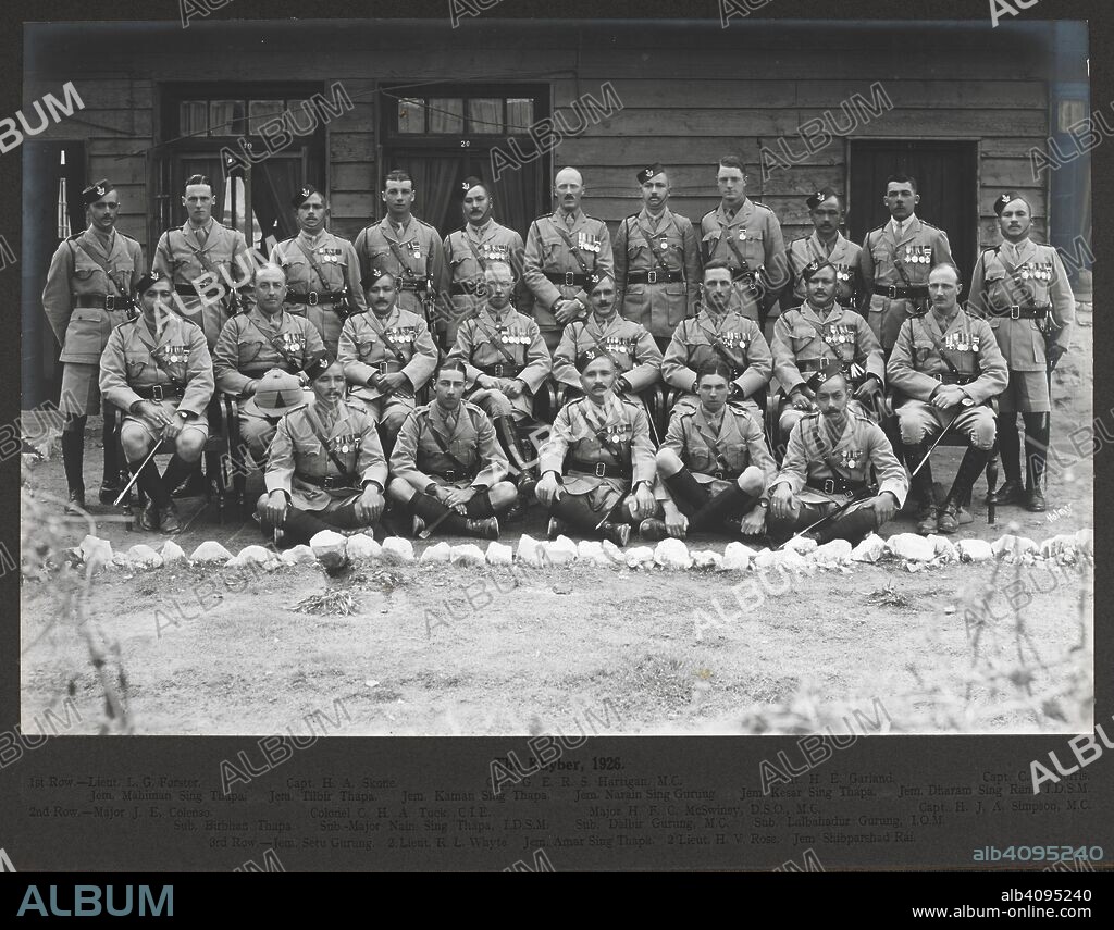 RANDOLPH BEZZANT HOLMES. The Khyber, 18 Februrary 1926. Formally posed group of British and Gurkha officers of the 3rd Gurkha Rifles, Identified as follows: (1st row, back): Lieut. L.G. Forster; Capt. H.A. Skone; Capt. G.E.R.S. Hartigan M.C.; Lieut. H.E. Garland; Capt. C.J. Morris; Jem. Mahiman Sing Thapa; Jem. Tilbir Thapa; Jem. Kaman Sing Thapa; Jem. Narain Sing Gurung; Jem. Kasar Sing Thapa; Jem. Dharam Sing Rana I.D.S.M. (2nd row): Major J.E. Colenso; Colonel C.H.A. Tuck C.I.E.; Major H.F.C. McSwiney D.S.O., M.C.; Capt. H.J.A. Simpson M.C.; Sub. Birbhan Thapa; Sub.-Major Nain Sing Thapa I.D.S.M.; Sub. Balbir Gurung M.C.; Sub. Lalbahadur Gurung I.O.M. (3rd row): Jem. Setu Gurung; 2/Lieut. R.L. Whyte; Jem. Amar Sing Thapa; 2/Lieut H.V. Rose; Jem. Shibparshad Rai. 1926. Gelatin silver print, 296x197mm]. Source: Photo 1076/2.(6).