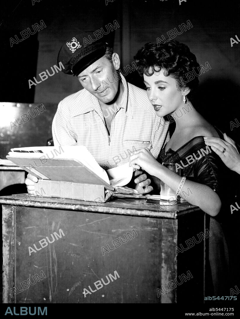 Severest Critic ... Elizabeth Taylor goes over stills of her in scenes from M-G-M's dramatic story "the girl who had everything" with husband, Michael Wilding. Film stars Miss Taylor, Fernando Lamas and William Powell. June 16, 1955.