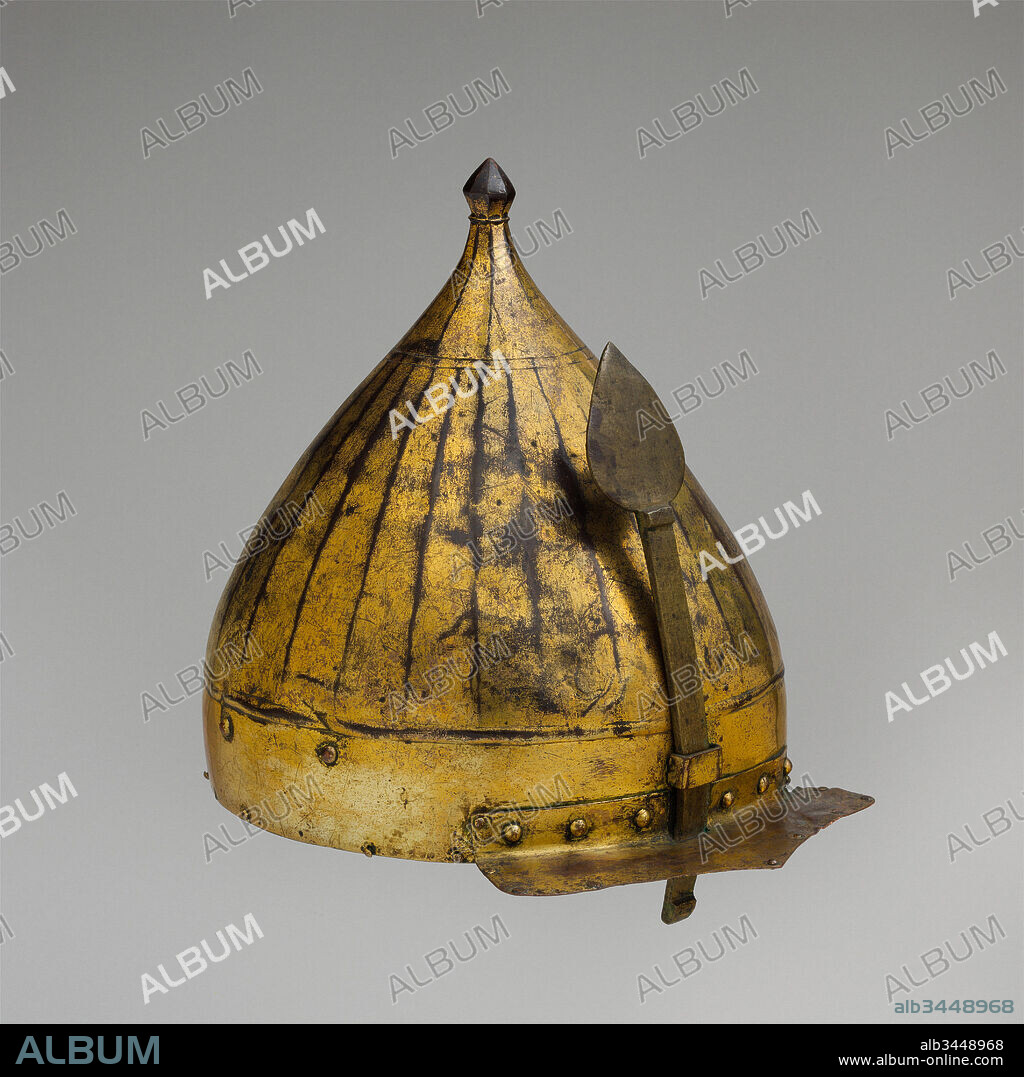 Helmet, late 16th century, Turkish, Copper alloy (tombak), gold, leather, textile, H. including nasal 14 1/4 in. (36.2 cm); H. excluding nasal 9 7/8 in. (25.1 cm); W. 9 in. (22.9 cm); D. 11 in. (27.9 cm); Wt. 2 lb. 13.7 oz. (1295.6 g), Helmets, This helmet is a type of ceremonial armor made of tombak, a copper alloy that was mercury gilded to imitate the appearance of gold. Tombak was made only in the Ottoman Empire and was used to produce helmets, shields, shaffrons, and several other types of metal objects such as candlesticks, braziers, and basins.