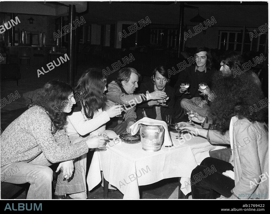 Fabrizo De Andre at the 'La Bussola' nightclub. The singer-songwriter Fabrizio De Andre drinking a toast with Sergio Bernardini, the owner of the 'La Bussola' nightclub, and the members of the band New Trolls. Viareggio, 1970s.