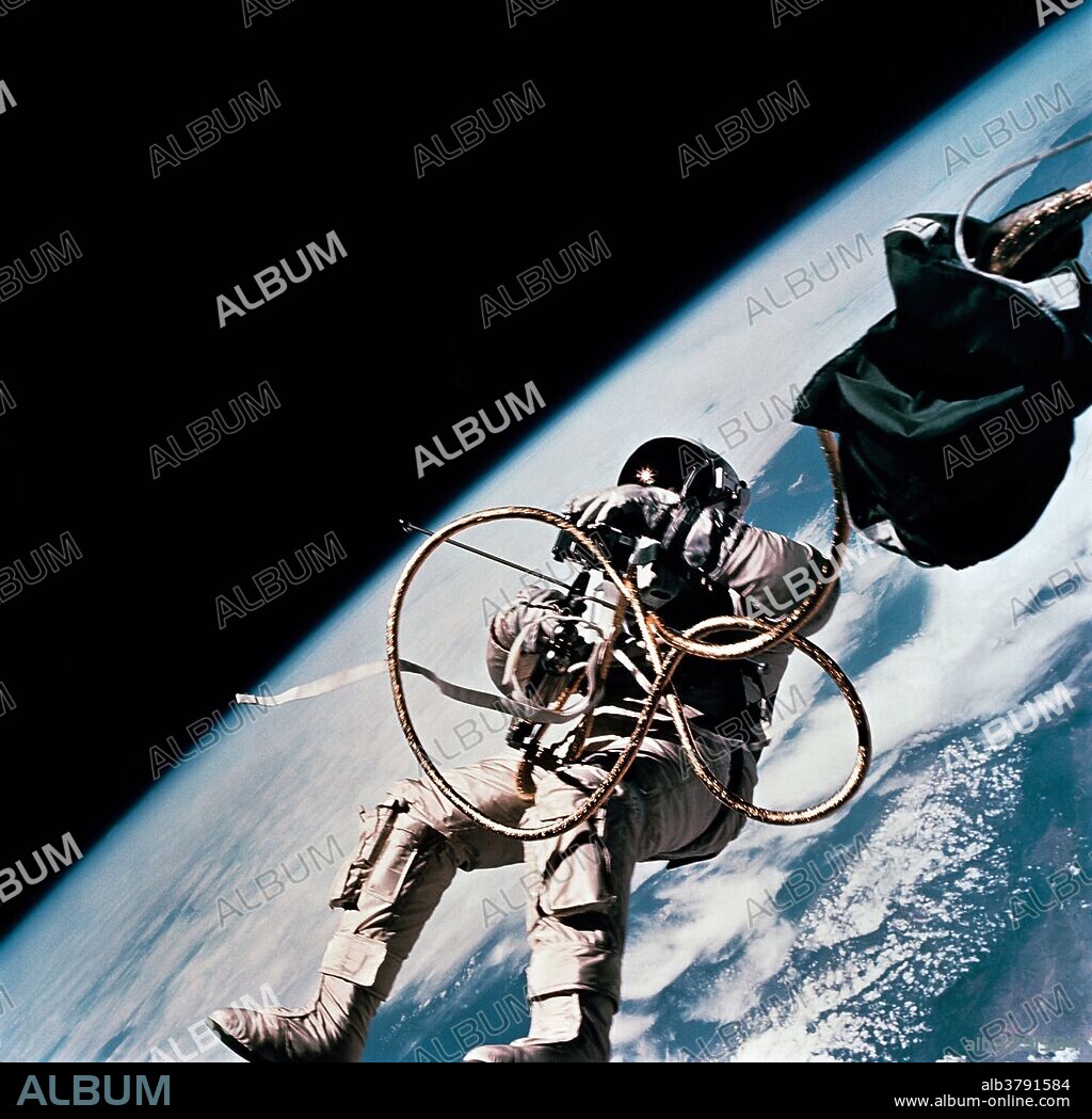 Astronaut Edward H. White II, pilot on the Gemini-Titan 4 spaceflight, is shown during his egress from the spacecraft. His face is covered by a shaded visor to protect him from the unfiltered rays of the sun. White became the first American astronaut to walk in space. He remained outside the spacecraft for 21 minutes during the third revolution of the Gemini-4 mission. He wears a specially designed spacesuit for the extravehicular activity (EVA). In his right hand, he carries a Hand-Held Self-Maneuvering Unit (HHSMU) with which he controlled his movements while in space. He was attached to the spacecraft by a 25 feet umbilical line and a 23 feet tether line, both wrapped together with gold tape to form one cord. He wears an emergency oxygen supply chest pack. Astronaut James A. McDivitt is command pilot for the Gemini 4 mission.