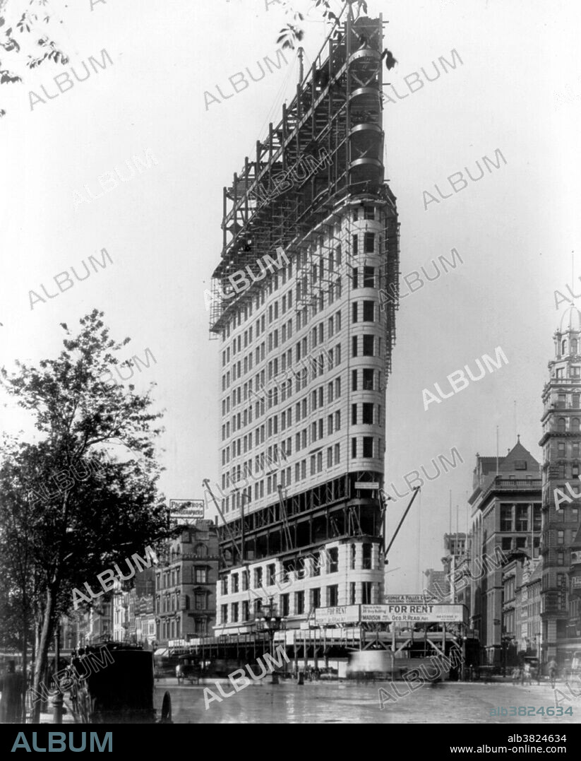 The Flatiron Building, originally the Fuller Building, is located at 175 Fifth Avenue in the borough of Manhattan, New York City, and is considered to be a groundbreaking skyscraper. The building sits on a triangular island-block formed by Fifth Avenue, Broadway and East 22nd Street, with 23rd Street grazing the triangle's northern peak. As with numerous other wedge-shaped buildings, the name "Flatiron" derives from its resemblance to a cast-iron clothes iron. The Flatiron Building was designed by Chicago's Daniel Burnham as a vertical Renaissance palazzo with Beaux-Arts styling. It epitomizes the Chicago school conception: like a classical Greek column, its facade is divided into a base, shaft and capital. The building was designated a New York City landmark in 1966, was added to the National Register of Historic Places in 1979, and designated a National Historic Landmark in 1989. Photographed by Charles L. Ritzmann, 1902.