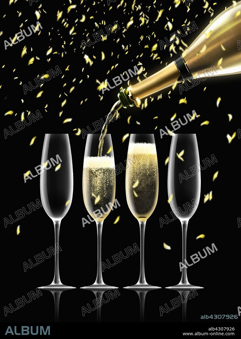 Confetti falling on gold champagne bottle filling four champagne flutes.