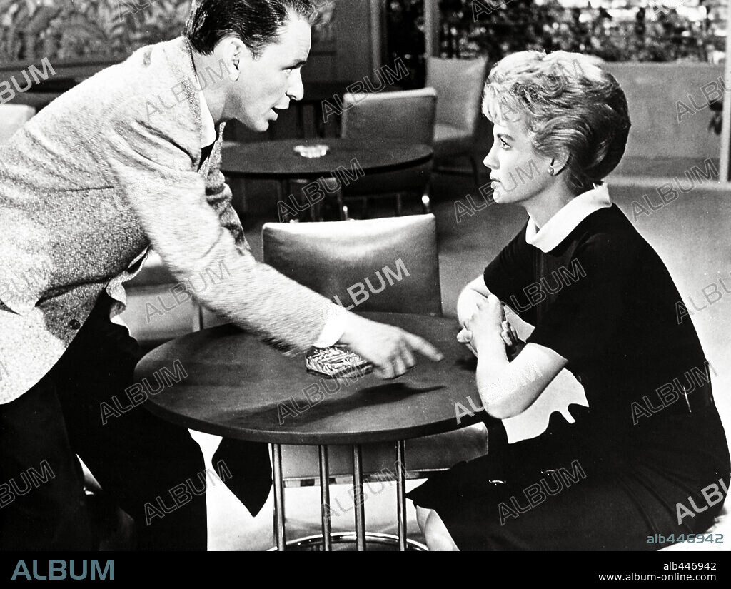ANGIE DICKINSON and FRANK SINATRA in OCEAN'S ELEVEN, 1960, directed by LEWIS MILESTONE. Copyright WARNER BROTHERS.