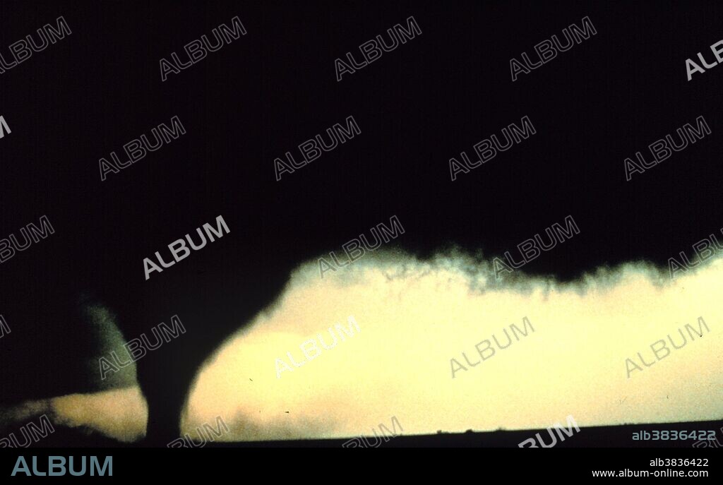 A tornado is a violent, dangerous, rotating column of air that is in contact with both the surface of the earth and a cumulonimbus cloud or, in rare cases, the base of a cumulus cloud. They are often referred to as a twister or a cyclone, although the word cyclone is used in meteorology in a wider sense, to name any closed low pressure circulation. Tornadoes come in many shapes and sizes, but are typically in the form of a visible condensation funnel, whose narrow end touches the earth and is often encircled by a cloud of debris and dust. Most tornadoes have wind speeds less than 110 miles per hour (177 km/h), are approximately 250 feet (80 m) across, and travel a few miles (several kilometers) before dissipating. The most extreme tornadoes can attain wind speeds of more than 300 mph (480 km/h), stretch more than two miles (3 km) across, and stay on the ground for dozens of miles (more than 100 km). Project Vortex - Probe 4, Tornado. South of Dimmitt, Texas June 2, 1995.
