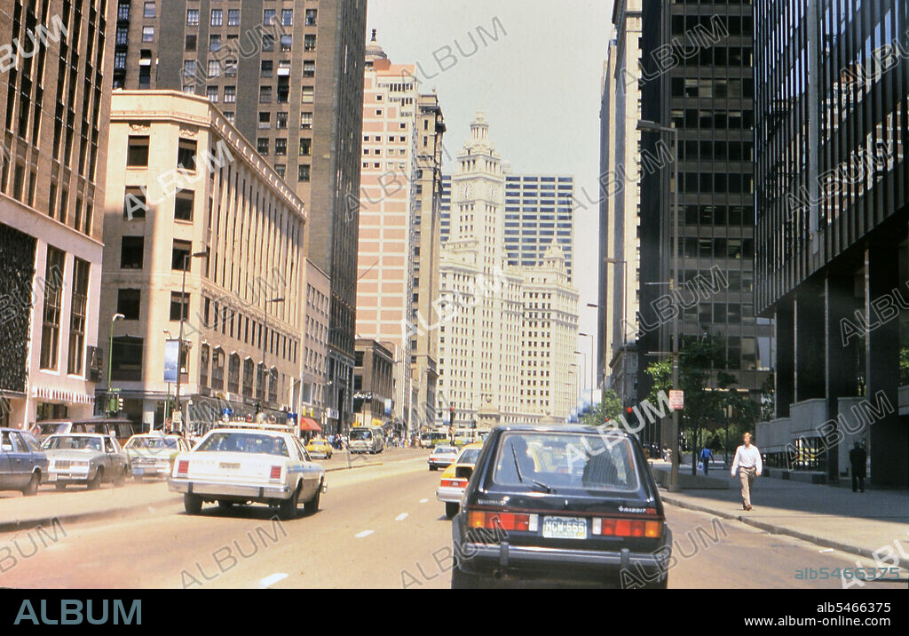 Traffic in downtown Chicago heading towards the Wrigley Building (a Volkswagen Rabbit and a Chicago Police car identified) circa 1985.