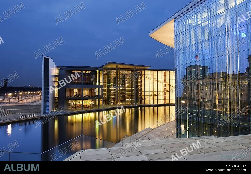 German Bundestag building reflected in the facade of the Marie Elisabeth Lueders House and Paul Loebe House on the opposite side of the Spree River in the evening, Berlin, Germany