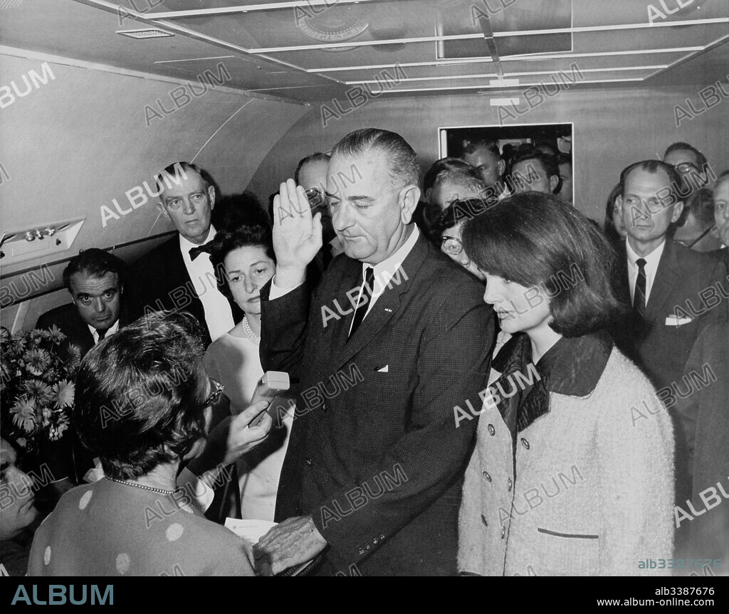 Vice President Lyndon Johnson, sworn in as President following the assassination of John F Kennedy November 22 1963. He is watched by Jacquie Kennedy the widow of the US President.